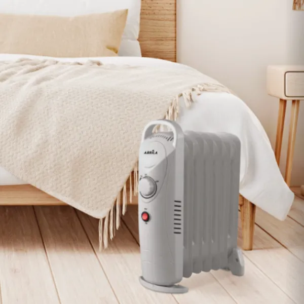 Radiador de aceite Confort 1200W de diseño compacto, ideal para estancias pequeñas, con termostato regulable y ruedas.