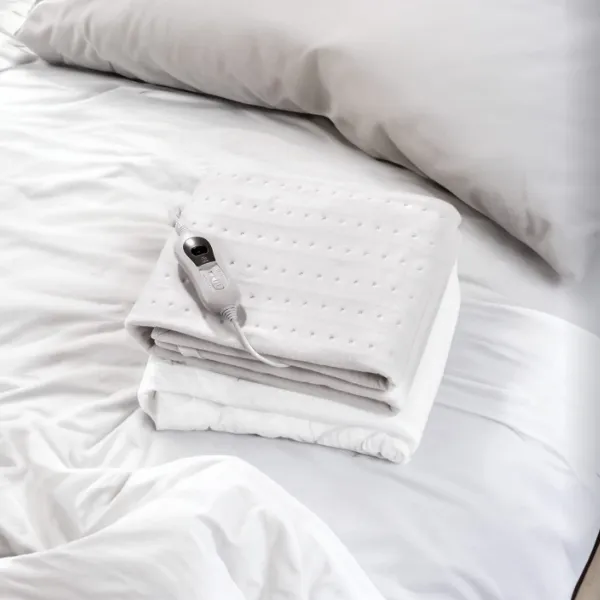 Calientacamas eléctrico blanco con mando digital, ideal para precalentar la cama en invierno y mantener el confort nocturno.