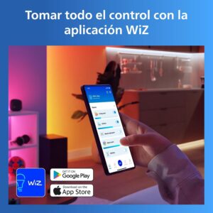 Mano sosteniendo un teléfono móvil configurando diferentes estancias de la casa dentro de la aplicación WiZ.